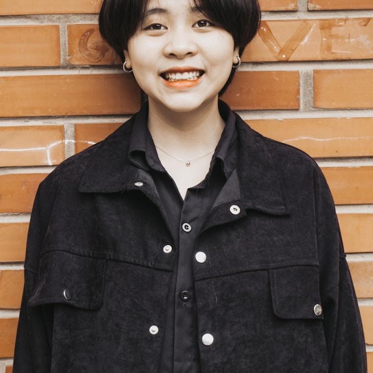 Jordan Kim, Lead Design Curator at Modern Portal Works, reviewing corporate floral arrangements